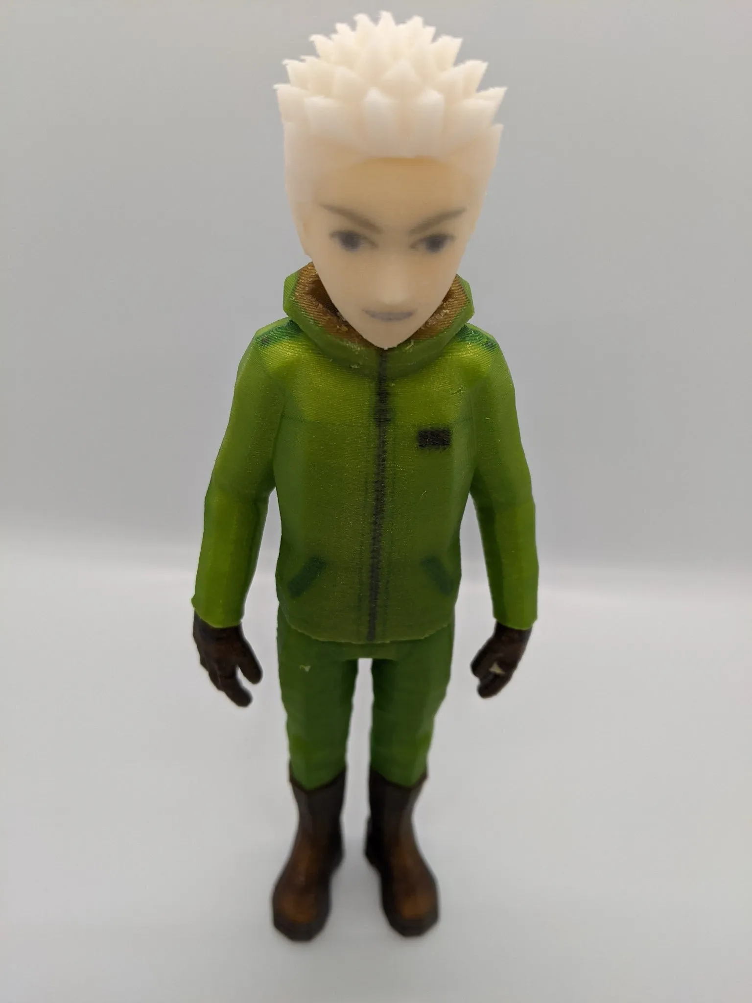 Full-color printed character figure in a green jacket