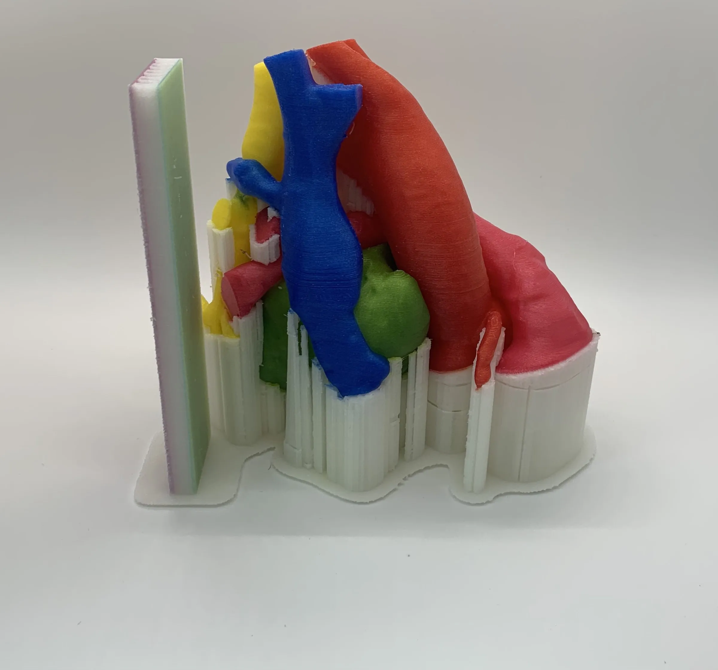 Full-color APD model still standing on white supports printed from the same polymer