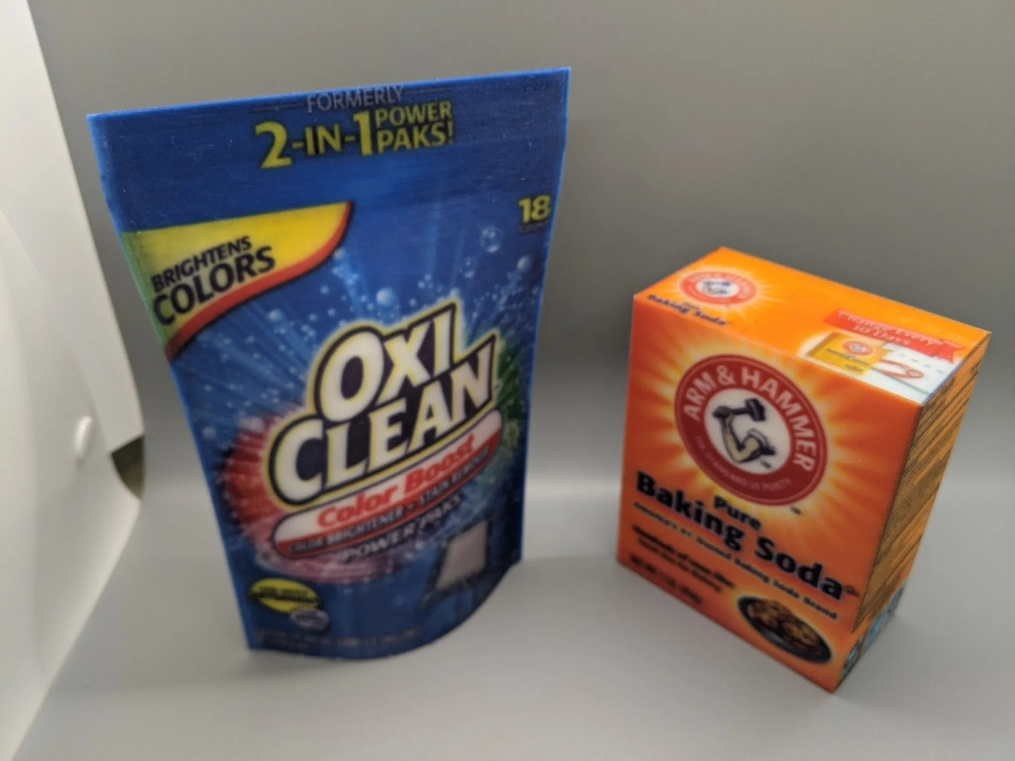 Printed replicas of a detergent pouch and a baking soda box