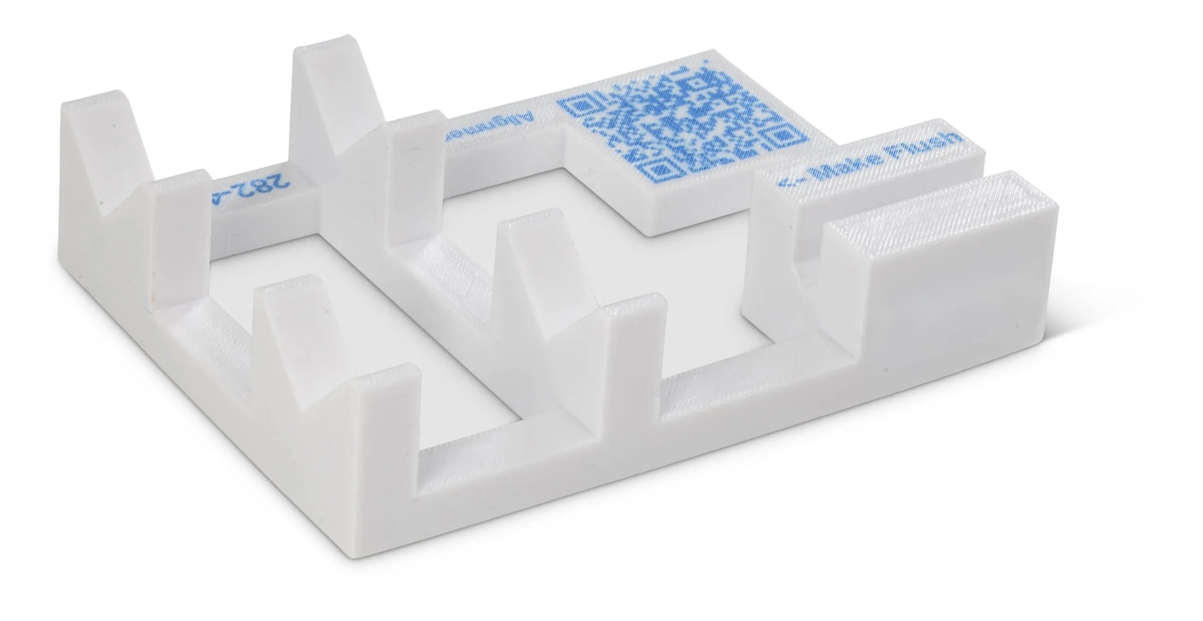 White assembly guide with an embedded QR code, part number and Make Flush instruction
