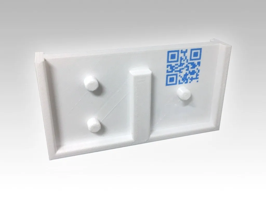 White gauge plate with an embedded QR code