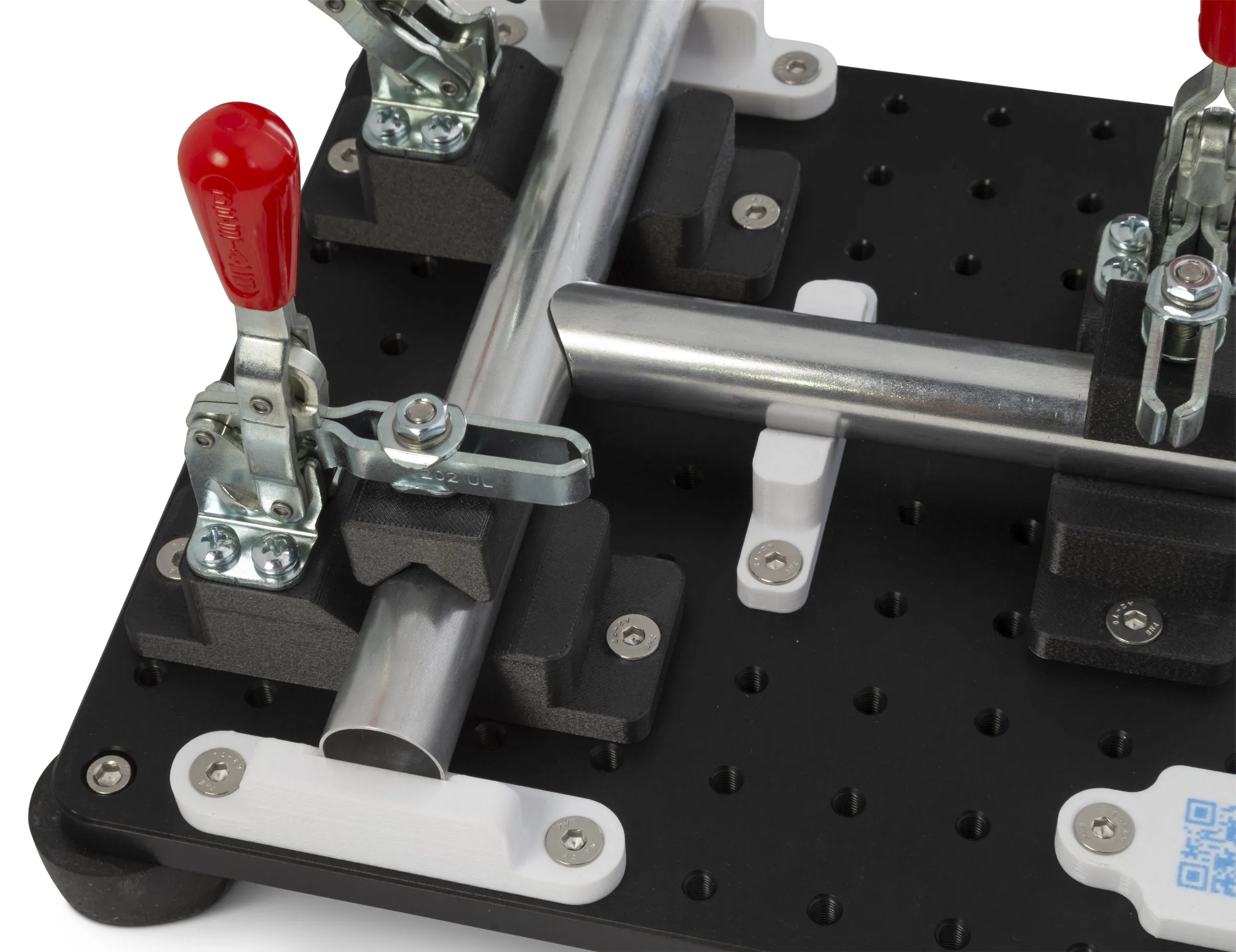 Tube assembly fixture with black and white Rizium locating blocks, toggle clamps and an embedded QR code label